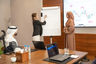 Work discussions and dialogues, new partnership deals, an Emirati work environment, dialogue and understanding among employees, unity and teamwork, office professions and jobs, ensuring a clear and comprehensive understanding of business, a foreign businesswoman discussing work methods and professional development with an Emirati woman.
