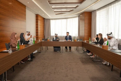 Joy and congratulations on signing new deals, an Emirati work environment, studying and analyzing new projects, dialogue and understanding among employees, unity and teamwork, professions and office jobs, ensuring a clear and comprehensive understanding of business, a foreign businessman in a business meeting inside an Emirati company with an Emirati Arab man.