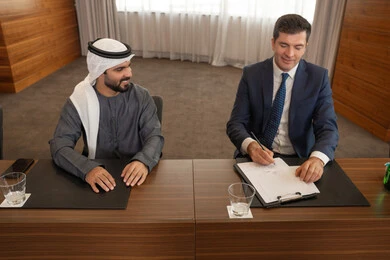 توقيع اتفاقيات جديدة، بيئة عمل إماراتية، دراسة وتحليل المشاريع الجديدة، الحوار والتفاهم بين الموظفين، الوحدة والعمل الجماعي، مهن ووظائف مكتبية، ضمان فهم واضح وشامل للاعمال، سيد اعمال اجنبي في اجتماع عمل داخل شركة اماراتية مع رجل عربي اماراتي