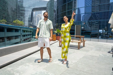 Luxury hotels and resorts in the UAE, pointing with an index finger at something, water sports activities, enjoying summer vacations, having fun, walking along the edge of the swimming pool, an Emirati Gulf Arab couple wearing casual clothes and taking a stroll