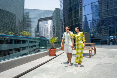 Chalets and tourist resorts, happy family atmosphere, water sports activities, enjoying summer trips, spending enjoyable times, walking along the edge of the swimming pool, an Emirati Gulf Arab couple wearing casual clothes and taking a stroll