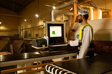 Using technology to control devices, monitoring and supervising laboratory machines, wooden furniture manufacturing factory, industrial professions and jobs, carpentry workshops in the Sultanate of Oman, a side view of an Arab Gulf Omani engineer wearing a turban and safety vest standing inside the factory. Using technology to control devices, monitoring and supervising laboratory machines, wooden furniture manufacturing factory, industrial professions and jobs, carpentry workshops in the Sultanate of Oman, a side view of an Arab Gulf Omani engineer wearing a turban and safety vest standing inside the factory.