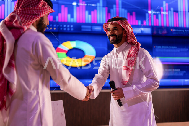 رجلان عربيان خليجيان سعوديان يتصافحان مع بعضهم، لقاء وتعارف ، اتفاق عمل بين رجال الاعمال ، صفقة تجارية ناجحة ، الاستثمار المالي والاقتصادي في سوق الاوراق المالية