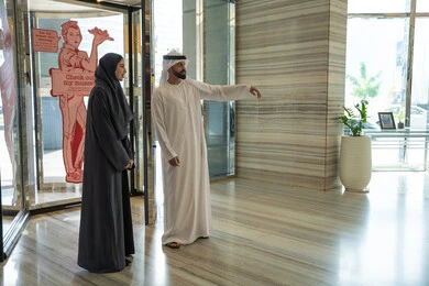 Weekend, a delightful couple's trip, spending the best times in the best Gulf hotels, an Emirati Arab couple dressed in traditional attire standing in the lobby of a tourist hotel, the concept of a happy family, pointing to something. Weekend, a delightful couple's trip, spending the best times in the best Gulf hotels, an Emirati Arab couple dressed in traditional attire standing in the lobby of a tourist hotel, the concept of a happy family, pointing to something.