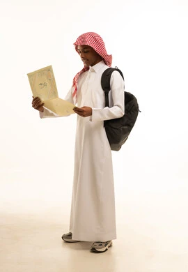 A portrait of a smiling Arab Saudi Gulf student wearing traditional attire and a shemagh, holding a school bag and a certificate in his hand, celebrating success and the end of the school year, the concept of excellence and graduation from school, education in Saudi Arabia, full-body shot, white background.