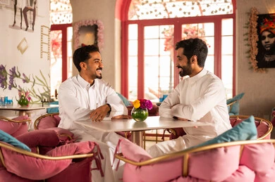 Developing social relationships, an upscale coffee shop in the Kingdom of Saudi Arabia, expressions of happiness and joy with friends, developing social relationships, spending enjoyable time with friends, enjoying the happy atmosphere, a group of Arab Gulf Saudi friends sitting at a table in the café.