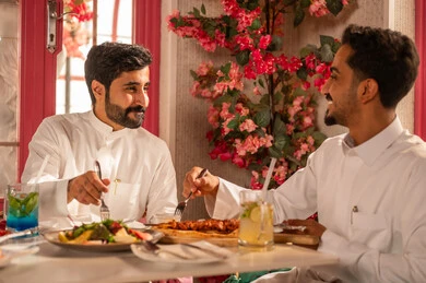 تعابير السرور والبهجة ، تبادل الأحاديث والاخبار, عزومة غداء لصديقان عربيان خليجيان سعوديان يقومان بتناول الأطعمة في أحد المطاعم الفاخرة، مائدة طعام مليئة بأصناف من المأكولات والمقبلات الشهية, ايماءات السعادة بقضاء اوقات ممتعه مع الاصحاب, لمة الاصدقاء على سفرة الإفطار الشهية