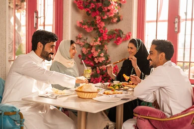 Expressions of joy and happiness, a dining table filled with a variety of delicious dishes and appetizers, gestures of happiness while spending enjoyable times with friends, a gathering of friends at a delicious breakfast table, a close-up image of a lunch invitation for Saudi Gulf Arab friends enjoying food at a luxury restaurant. Expressions of joy and happiness, a dining table filled with a variety of delicious dishes and appetizers, gestures of happiness while spending enjoyable times with friends, a gathering of friends at a delicious breakfast table, a close-up image of a lunch invitation for Saudi Gulf Arab friends enjoying food at a luxury restaurant.