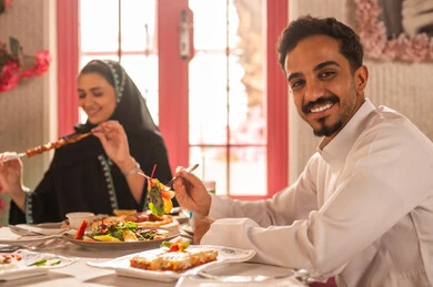 تعابير السرور والبهجة ،مائدة طعام مليئة بأصناف من المأكولات والمقبلات الشهية, ايماءات السعادة بقضاء اوقات ممتعه مع الاصحاب, لمة الاصدقاء على سفرة الإفطار الشهية, صورة مقربة لعزومة غداء لاصدقاء عرب خليجيين سعوديين  يقومون بتناول الأطعمة في أحد المطاعم الفاخرة