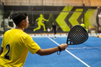 A youth entertainment and sports program, the Saudi Tennis Federation, two young Arab Gulf Saudis practicing tennis and playing racquet sports in public courts, the concept of fitness and agility, sports games and training.