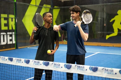 Recreational activities and youth sports, games and sports training, the concept of fitness and agility, two young Arab Gulf Saudis practicing tennis and playing racquet sports in public courts, the Saudi Tennis Federation.