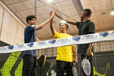 The concept of fitness and agility, the Saudi Tennis Federation, entertainment and sports for youth, playing tennis in public courts, a group of young Arab Gulf Saudis wearing sportswear practicing tennis.