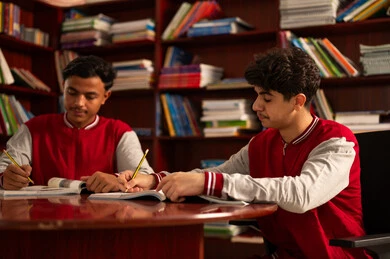 Reviewing daily lessons, completing school assignments, preparing for the new school year, education in Saudi Arabia, returning to school, studying for school exams, two Arab Gulf students from Saudi Arabia are solving school lessons.