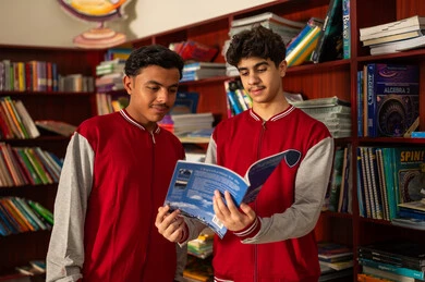 Education in the Kingdom of Saudi Arabia, enjoying reading school books, modern academies and schools, Arab Saudi Gulf students wearing school uniforms standing in the school library, doing homework. Education in the Kingdom of Saudi Arabia, enjoying reading school books, modern academies and schools, Arab Saudi Gulf students wearing school uniforms standing in the school library, doing homework.