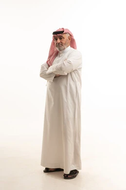 Standing with arms crossed in gestures of self-confidence, elegance, and handsomeness, and attention to appearance, a portrait of an elderly Saudi Arabian Gulf man wearing traditional attire, full-body, white background. Standing with arms crossed in gestures of self-confidence, elegance, and handsomeness, and attention to appearance, a portrait of an elderly Saudi Arabian Gulf man wearing traditional attire, full-body, white background.