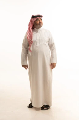 Standing upright with gestures of self-confidence, elegance, and handsomeness, and attention to appearance, a portrait of an elderly Saudi Arabian Gulf man wearing traditional attire, full-body, white background. Standing upright with gestures of self-confidence, elegance, and handsomeness, and attention to appearance, a portrait of an elderly Saudi Arabian Gulf man wearing traditional attire, full-body, white background.