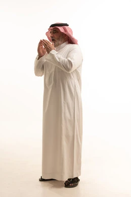 The occurrence of a cold, cough, flu, and sore throat, a portrait of an elderly Arab Gulf Saudi man wearing traditional attire, opening his hands near his mouth while sneezing, feeling chest pain, gestures of illness, fatigue, runny nose, and difficulty breathing, full body length, white background.