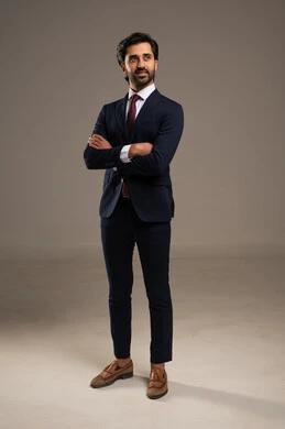 Taking a personal photo for official documents, standing with arms crossed in gestures of self-confidence, the concept of elegance and masculinity, a portrait of a Saudi Gulf Arab businessman wearing a formal suit, attention to external appearance, white background.