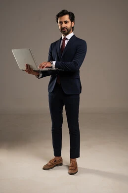 إدارة شؤون الأعمال وتنظيمها، استخدام التقنيات الحديثة المتطورة، عقد إجتماع عمل عبر الإنترنت، بورتريه لرجل اعمال عربي خليجي سعودي يرتدي البدلة الرسمية يقوم بالعمل على الحاسب المحمول, دمج التكنولوجيا في الحياة العملية، الجسم بالطول الكامل، خلفية بيضاء