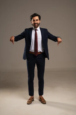 Pointing with the index finger downwards, gestures and expressions of joy and happiness, the concept of elegance and masculinity, a portrait of an Arab Gulf Saudi businessman wearing a formal suit, attention to external appearance, full-body, white background.