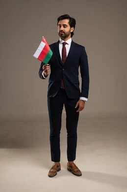 The concept of love for the homeland and belonging to it, participation in national holidays and events, celebrating the anniversary of Oman's National Day, pride and honor in the symbols and the Omani flag, a portrait of a young Arab Gulf Omani man wearing a formal suit holding the flag of the Sultanate of Oman in his hand, full-body, white background. The concept of love for the homeland and belonging to it, participation in national holidays and events, celebrating the anniversary of Oman's National Day, pride and honor in the symbols and the Omani flag, a portrait of a young Arab Gulf Omani man wearing a formal suit holding the flag of the Sultanate of Oman in his hand, full-body, white background.