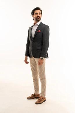 Attention to appearance, the concept of elegance and masculinity, looking at something with gestures of self-confidence, a portrait of an Arab Gulf Saudi businessman wearing a formal suit, full-body, white background.