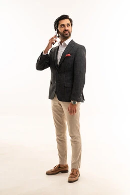 Making a phone call via mobile, integrating technology into practical life, using modern and advanced technology, managing and organizing work affairs online, a portrait of an Arab Gulf Saudi businessman wearing a formal suit holding a mobile phone in his hand, full body, white background.