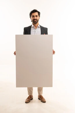 White rectangular mockup, advertising and marketing campaigns, raising the index finger and pointing to the board, the concept of elegance, masculinity, and attention to appearance, a portrait of a young Arab Gulf Saudi man wearing a formal suit holding a white rectangular board, full body, white background.