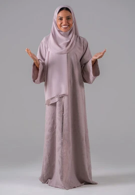 The concept of peace and greeting, gestures of joy and happiness, facial expressions and different body language, a portrait of an Arab Gulf Saudi woman wearing an abaya and hijab raising her hands with welcoming expressions, gray background.