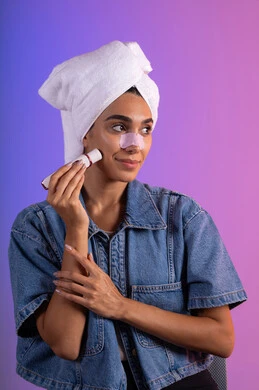 ماسك تنظيف المسام، إستخدام أداة شفط لحب الشباب، بورترية مقرب لإمرأة عربية خليجية سعودية ترتدي الزي الكاجوال تضع منشفة الرأس  تستخدم لصقات الأنف للتخلص من الرؤوس السوداء والجلد الميت، مفهوم العناية والإهتمام بنضارة وتحسين البشرة، خلفية ملونه