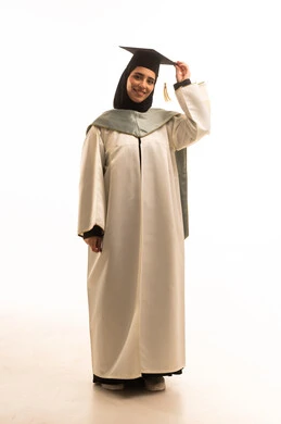 University graduation party, gestures of happiness at achieving the dream of success, a portrait of a smiling, veiled Saudi Gulf Arab graduate wearing graduation attire, holding the cap with expressions of joy and excitement, celebrating the completion of university studies, full-body shot, white background.