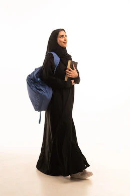 Preparation for the new university academic year, universities and educational schools, a portrait of a Gulf Arab Saudi university student carrying a university bag and holding a book in her hand, a diligent young Saudi woman eager to go to university, full-body shot, white background.
