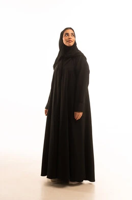 Standing upright and ready, the concept of femininity and elegance, attention to appearance, a portrait of a Saudi Arabian Gulf woman wearing a hijab and an abaya looking at something with expressions of joy, full-body image, white background.