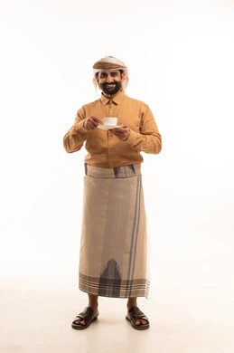 Enjoying hot drinks and warm winter herbs, spending leisure time sipping the favorite drink, a portrait of a Yemeni Arab man wearing a shirt and a traditional wrap, drinking coffee with gestures of happiness and joy, full-body, white.