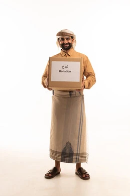 Providing essential supplies for the poor, a charitable organization and humanitarian initiative, a portrait of an Arab Yemeni man wearing a shirt and a sarong with a turban holding a cardboard box, the concept of assistance and donation, full-body, white background.