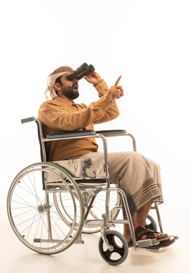 Seeing distant things and bringing them closer, a love for exploration and adventure, a portrait of a Yemeni Arab man wearing a shirt and a sarong with a turban sitting in a wheelchair looking through binoculars pointing at something, gestures of enjoyment and pleasure, white background. Seeing distant things and bringing them closer, a love for exploration and adventure, a portrait of a Yemeni Arab man wearing a shirt and a sarong with a turban sitting in a wheelchair looking through binoculars pointing at something, gestures of enjoyment and pleasure, white background.