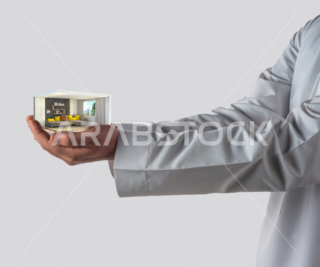 صورة مقربة ليد رجل عربي خليجي سعودي يحمل بين يديه تصميم منزل بتقنية ثلاثية الأبعاد ، إستثمار الأموال لشراء بيت جديد ، الإستقرار و إمتلاك منزل جديد