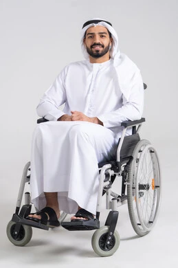 Providing devices and equipment that assist with movement and mobility, improving the lives of individuals with physical disabilities, a portrait of an Emirati Arab man with special needs wearing a kandura and a white ghutrah sitting in a wheelchair, looking at the camera with gestures of happiness and joy, white background.