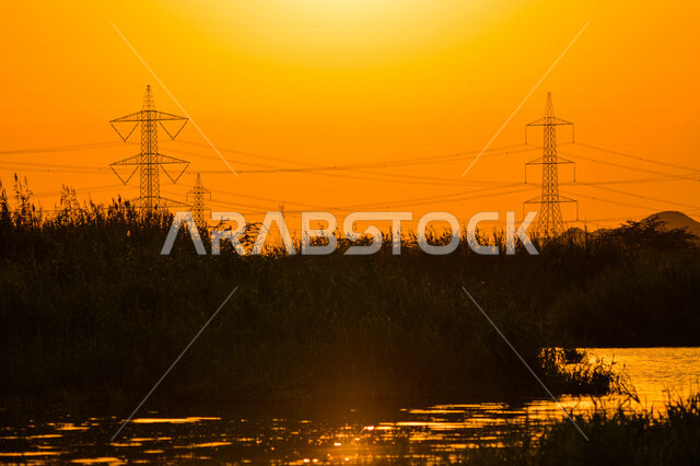 Beautiful aesthetic picture of orange sunset, creative sunset in Jeddah, beauty of nature in Saudi Arabia at sunset, silhouette of picturesque nature in Saudi Arabia, power station in Jeddah at sunset, electric power