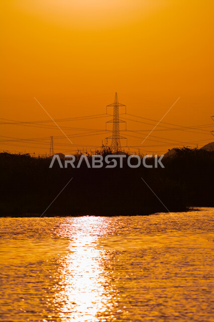 Beautiful aesthetic picture of orange sunset, creative sunset in Jeddah, beauty of nature in Saudi Arabia at sunset, silhouette of picturesque nature in Saudi Arabia, power station in Jeddah at sunset, electric power