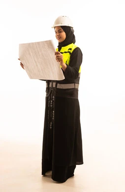 Review of the construction plan, engineering and architectural construction, a portrait from behind of a smiling Saudi Gulf Arab female engineer wearing a helmet and safety vest holding a construction plan, the progress and development of Saudi Arabia by the hands of the women of the nation, attention to work affairs, white background.