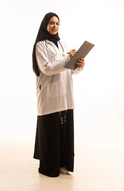 Providing medical service and consultation, a portrait of an Arab Gulf Saudi female doctor wearing a white coat and stethoscope, holding a notebook with general information about the patient's condition, women's professions and jobs, studying and reviewing patient cases, full-body, white background.
