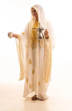 The concept of generosity and hospitality, the day we began in 1727 AD, the anniversary of the establishment of the first Saudi state on February 22, a close-up portrait of a young Arab Gulf Saudi woman wearing the shayla and the nashl pouring coffee from a brass dallah, white background.