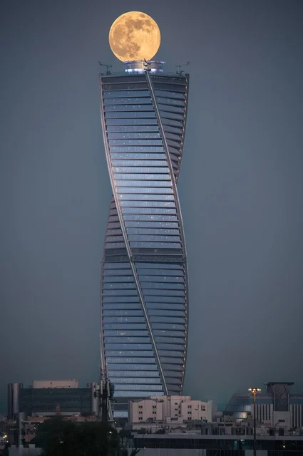 Urban growth and development, the Majdoul Tower in Riyadh at night, architectural engineering arts of skyscrapers in the Kingdom of Saudi Arabia, tourist landmarks of Riyadh, famous commercial buildings and towers, the full moon over the tower (Badr).