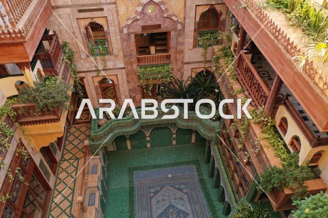 Embodiment of the atmosphere of the courtyards of ancient heritage houses in the Kingdom of Saudi Arabia, the concept of tranquility and relaxation, details of gypsum decoration in home decor, simple life in historical homes, love for the old traditional style, enjoying the distinctive natural views.