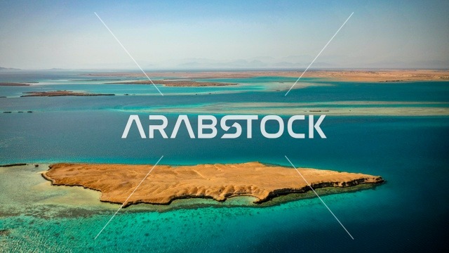 Different shapes and forms of the island, a nature that combines luxury and tranquility, recreational summer activities, the modern design of Sandala resorts and yacht marinas, the turquoise waters of the Red Sea surround the island with its white beaches, an aerial image of Sandala Island in the NEOM project in northwestern Saudi Arabia.
