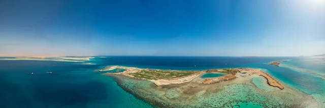 A different island shape, a nature that combines luxury and tranquility, recreational summer activities, the modern design of Sindalah resorts and yacht marinas, the turquoise waters of the Red Sea surround the island with white beaches, an aerial image of Sindalah Island in the NEOM project in northwestern Saudi Arabia.
