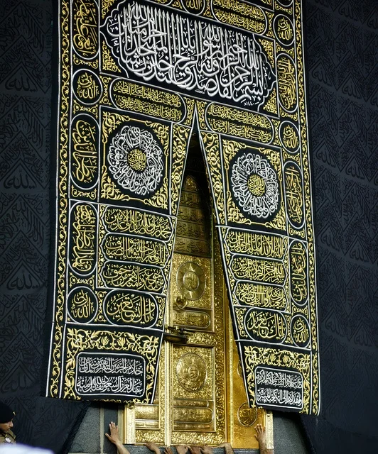The black silk curtain of the Kaaba door, engraved with verses from the Holy Quran, showcases the Kaaba's covering embroidered with golden and silver threads, an introduction to the culture and history of the holy lands, Islamic places in Jeddah, Saudi Arabia, and distinctive religious and archaeological artifacts.