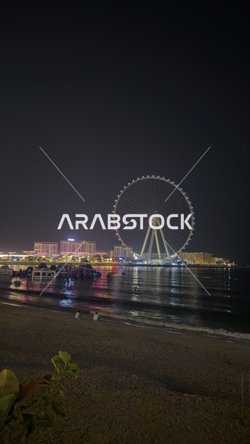 Aesthetic image of the Dubai towers overlooking the Arabian Gulf, the beauty of the waterfront in Dubai, Ain Dubai, the tallest Ferris wheel in the world, tourism in the United Arab Emirates, famous tourist attractions in Dubai, architectural engineering art in the Emirates.