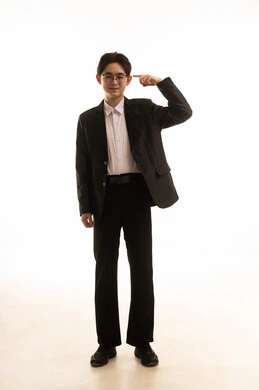 A gesture indicating this place (here), a portrait of an Asian man wearing a suit and pointing with his index finger at something, a full-body image, a gesture indicating a specific location, white background.